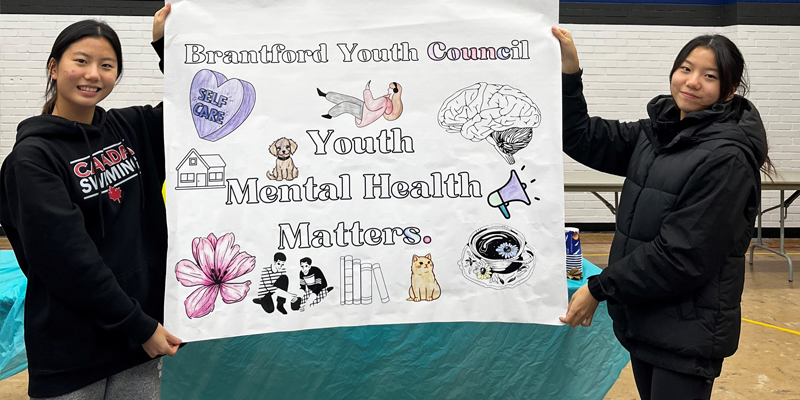 Members of Brantford Youth Council hold up a banner that says Youth Mental Health Matters