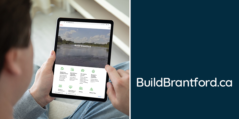 A person on an ipad visiting the BuildBrantford.ca website