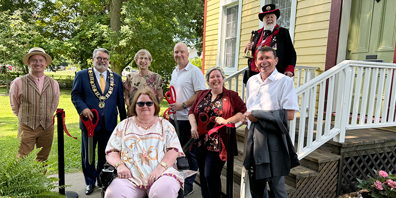 Cutting the ribbon for the new telephone museum exhibit