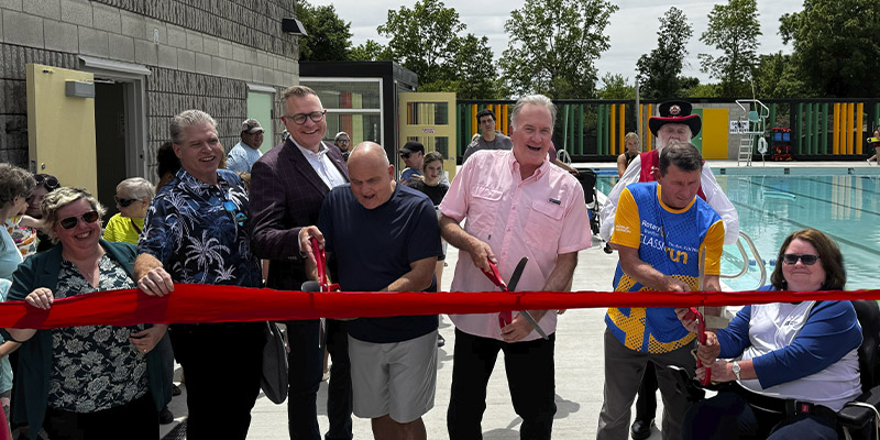 Group cutting the ribbon at the newly renovated Woodman Pool