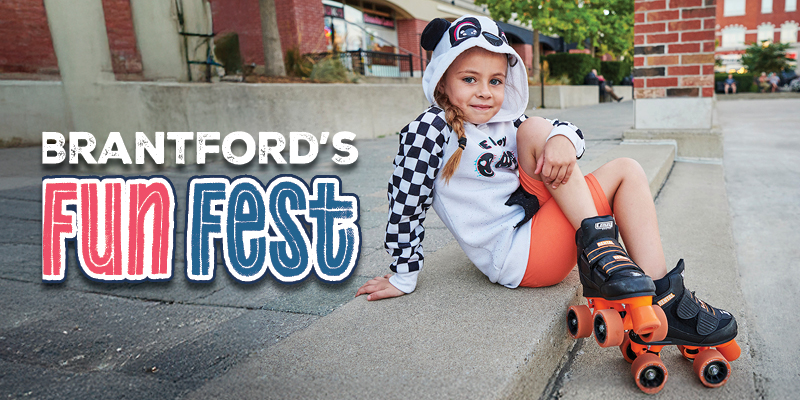 Girl sitting on the steps with roller skates on smiling