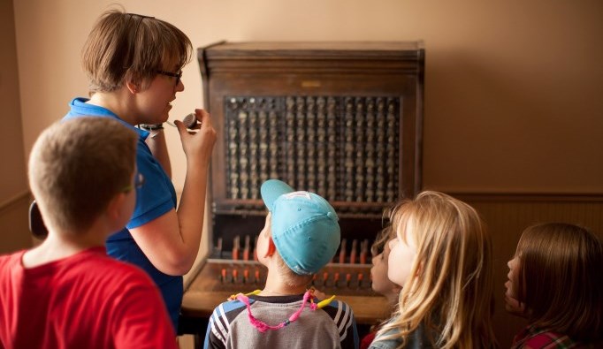 children looking at original phone switchboard